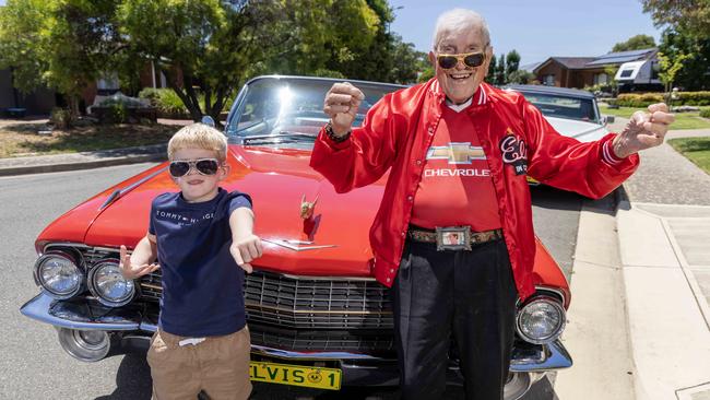 Elvis fan Pat Staltari, who turns 100 on Monday, with his great-grandson Carter Snow, 6, and his red 1959 Cadillac convertible. Picture: Kelly Barnes