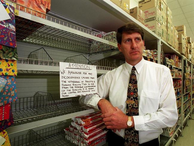 Manager of Woolworths Chermside store David Illidge with empty shelves after an Arnotts biscuits recall.