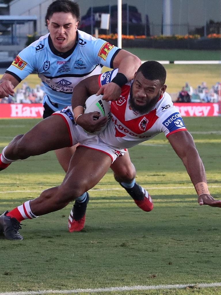 Mikaele Ravalawa of the Dragons scores a try despite the efforts of Mawene Hiroti of the Sharks during the Round 5 NRL match. Picture: AAP Image/Brendon Thorne.