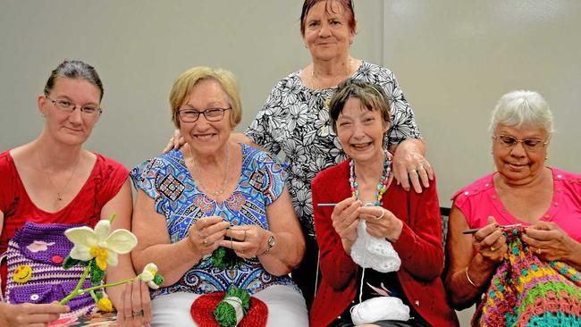 CLICK, CLICK: From left, Toulouse Casey, Edie Bellis, Mary Fulwood, Judith Houlahan and (at back) Bev Chelepy meet at the South Rockhampton Library to craft warm ware for locals in need. Picture: Jann Houley