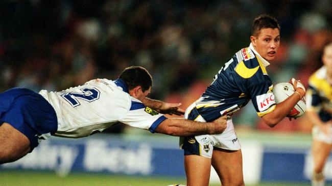 Scott Prince attempts to get past a lunging Bulldogs in 200.