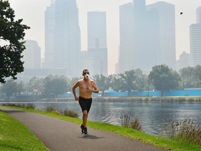 A runner braving the smoky conditions along the Yarra River. Picture: Nicki Connolly