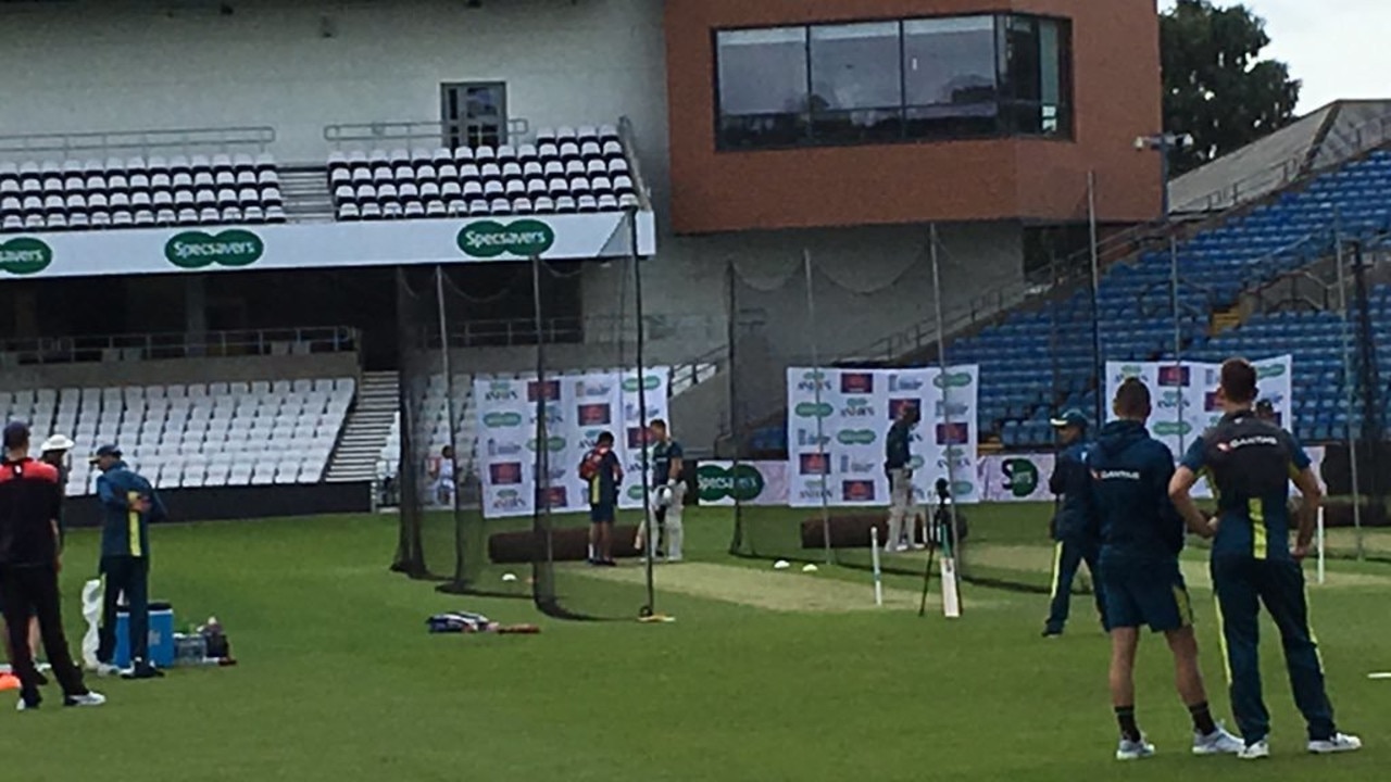 Marnus Labuschange is checked by the Australian team doctor after being struck in the nets by Mitchell Starc.