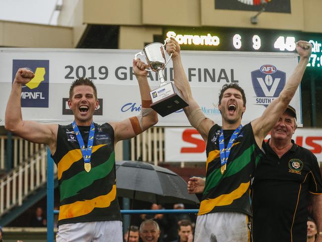 Dromana coach Rikki Johnston and captain Terry Wheeler hold up the premiership cup after the 2019 MPNFL Division 1 grand final at Frankston Park. Picture: Valeriu Campan