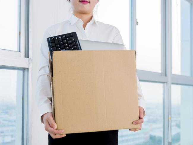 RendezView. Quit. Resign. Businesswoman carrying a box in an office.