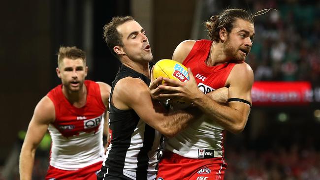 Jordan Foote is tackled by Collingwood’s Steele Sidebottom while playing for the Swans in 2017. Picture: Ryan Pierse/Getty Images