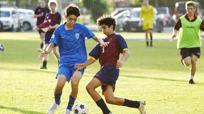 Matty McWhinney and Anthony Taifalos compete for the ball in the regional play-off match for the Bill Turner Cup between Cairns State High School and St Augustine's College. Picture: Brendan Radke