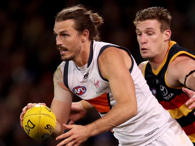 ADELAIDE, AUSTRALIA - JUNE 08: Phil Davis of the Giants is tackled by Josh Jenkins of the Crows during the 2019 AFL round 12 match between the Adelaide Crows and the GWS Giants at the Melbourne Cricket Ground on June 08, 2019 in Melbourne, Australia. (Photo by James Elsby/AFL Photos/Getty Images)