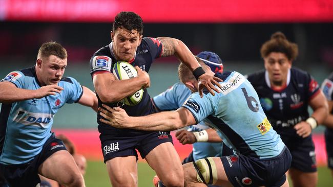 ;Melbourne Rebels player Matt To'omua (C) is tackled by Waratahs player Lachlan Swinton (R) during the Super Rugby match between Australia's Waratahs and Melbourne Rebels in Sydney on July 24, 2020. (Photo by PETER PARKS / AFP) / -- IMAGE RESTRICTED TO EDITORIAL USE - STRICTLY NO COMMERCIAL USE --