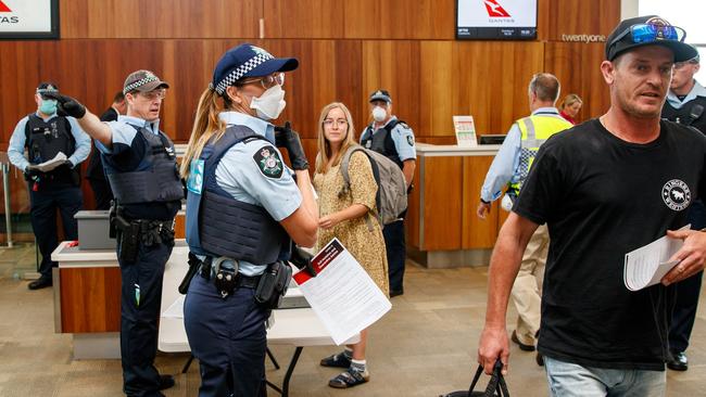 Police check passengers arriving at Adelaide airport on Tuesday afternoon shortly before tough travel restrictions came into force. Picture: Matt Turner