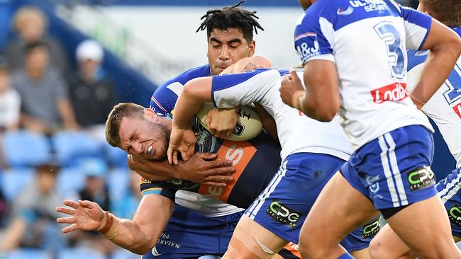 Jai Arrow is tackled by the Bulldogs. Picture: AAP Image