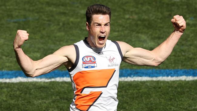 Jeremy Cameron flexes some muscle after kicking the opening goal of the grand final.