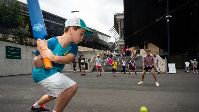 The light was good enough for kids to have a hit out the back of the ground. Photographer: Tom Parrish