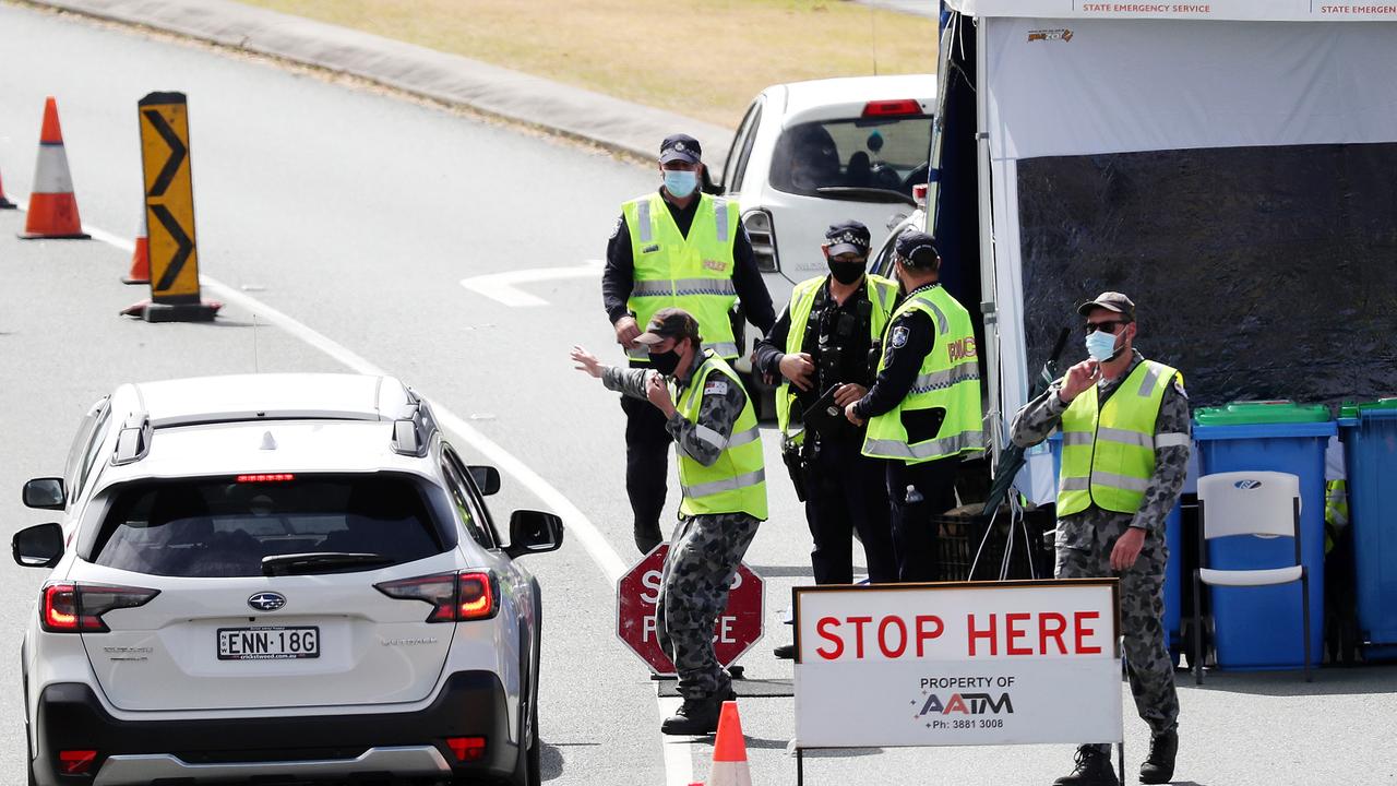 Defence force members check cars at the Queensland border in Coolangatta. Picture: Nigel Hallett