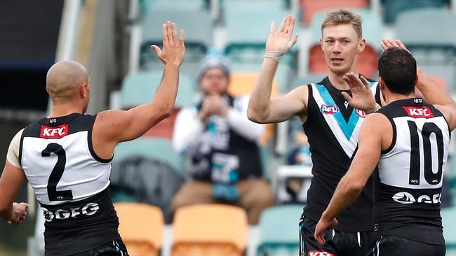 Todd Marshall celebrates a goal with Sam Powell-Pepper and Travis Boak.