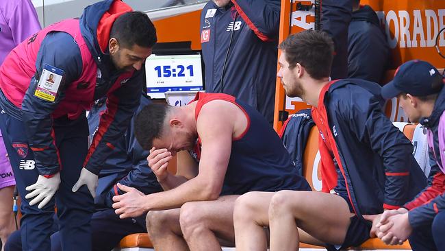 MELBOURNE, AUSTRALIA - AUGUST 10: Steven May of the Demons sits on the bench after injuring his hamstring during the round 21 AFL match between the Melbourne Demons and the Collingwood Magpies at Melbourne Cricket Ground on August 10, 2019 in Melbourne, Australia. (Photo by Quinn Rooney/Getty Images)