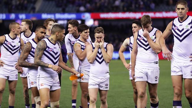 MELBOURNE, AUSTRALIA - JULY 28: Brandon Matera of the Dockers (C) and team mates look dejected after the round 19 AFL match between the Western Bulldogs and the Fremantle Dockers at Marvel Stadium on July 28, 2019 in Melbourne, Australia. (Photo by Matt King/Getty Images)