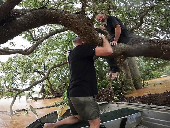 Gavin Dear, 57, spots and rescues local gold prospector Wayne from a tree at Rossville. This was his first of two rescues on Monday in his tinnie. Picture: Georgie Duff