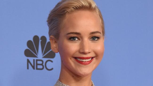 TOPSHOT - Jennifer Lawrence poses with the award for Best Actress in a Motion Picture, Comedy for her role in “Joy,” in the press room at the 73nd annual Golden Globe Awards, January 10, 2016, at the Beverly Hilton Hotel in Beverly Hills, California. AFP PHOTO / FREDERIC J. BROWN / AFP / FREDERIC J BROWN