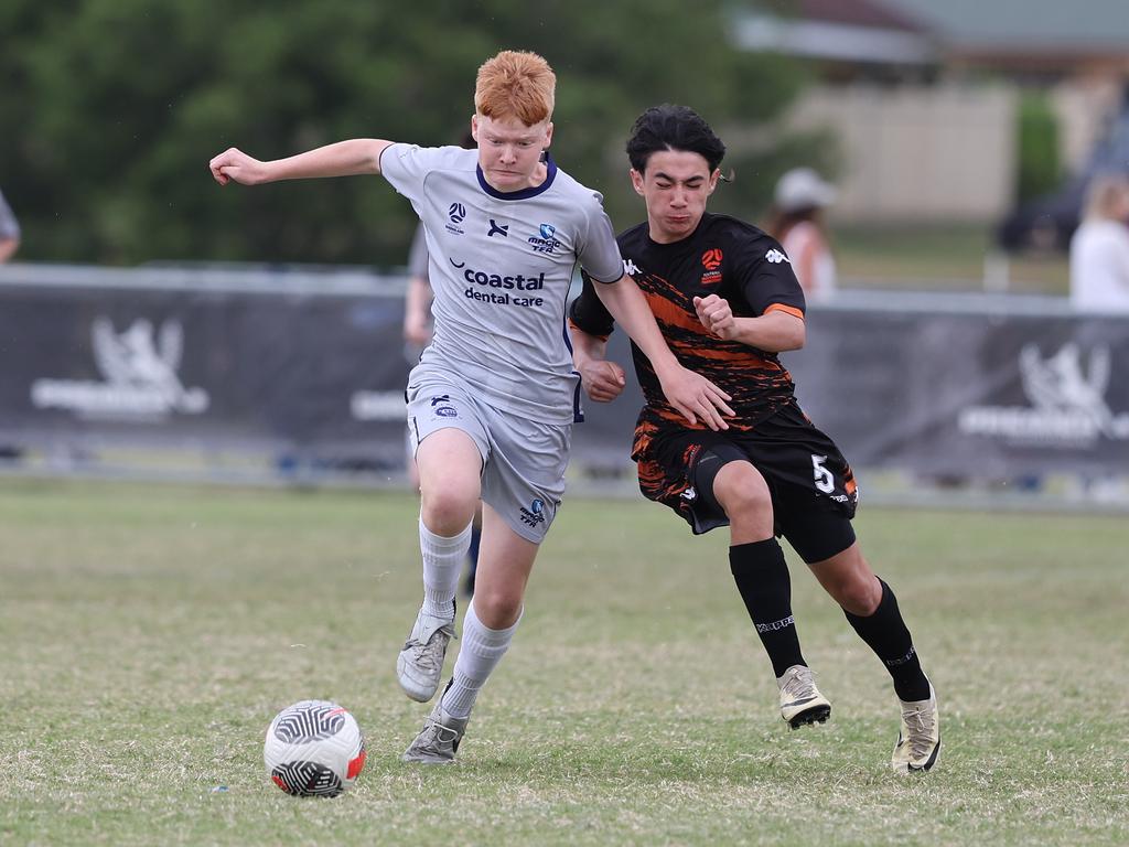 Premier Invitational Football 2024 tournament at Glennon Park Nerang. Field 2...Magic Utd (grey) V Football NT Utd. Picture Glenn Hampson