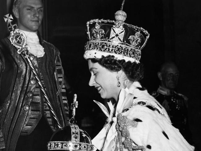 Queen Elizabeth II, wearing the Imperial State Crown and carrying the Orb, arrives at Buckingham Palace from Westminster Abbey, after her coronation in 1953. Picture: Corbis via Getty Images