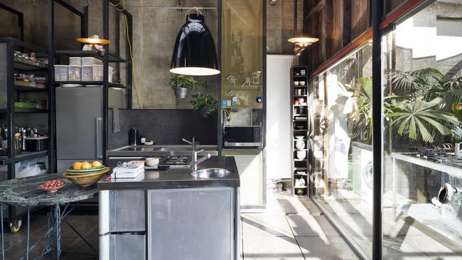 A stainless-steel kitchen continues the industrial theme.