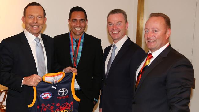 The-then prime minister Tony Abbott, former Crow Andrew McLeod, Christopher Pyne and Crows chairman Rob Chapman with an indigenous inspired guernsey, pictured in 2014.