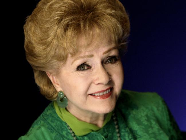 FILE - This Oct. 14, 2011 file photo shows actress Debbie Reynolds posing for a portrait in New York. The Los Angeles Times and celebrity website TMZ have reported that Reynolds has been rushed to the hospital Wednesday, Dec. 28, 2016, after suffering a medical emergency in Los Angeles one day after her daughter Carrie Fisher died. (AP Photo/Richard Drew, File)
