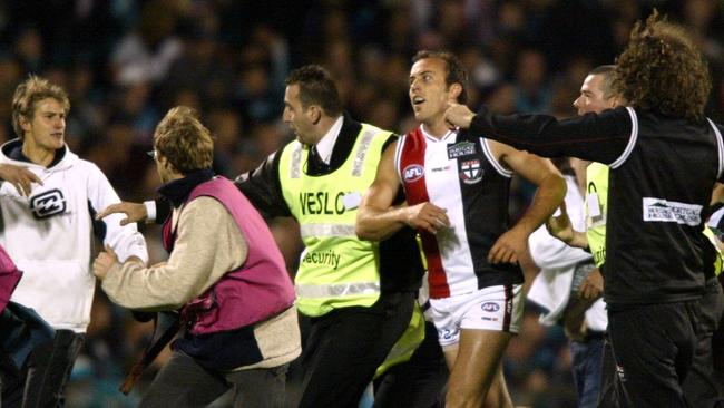 Security and fans surround Fraser Gehrig after his 100th goal.