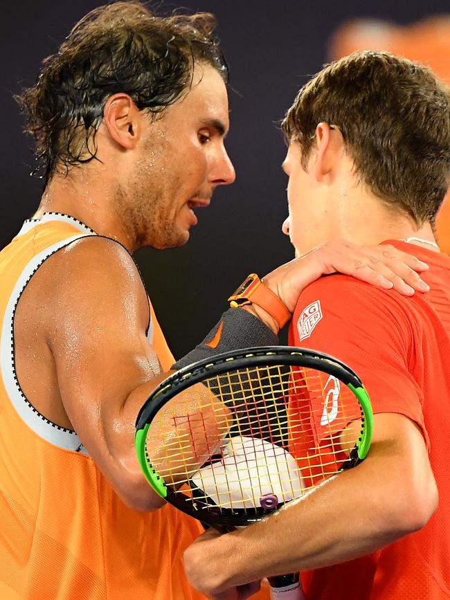 Alex De Minaur is consoled by Rafael Nadal after losing in the third round at the Australian Open. Picture: Quinn Rooney/Getty Images