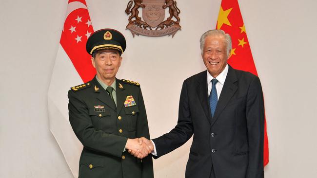 Singaporean Defence Minister Ng Eng Hen, right, welcomes his Chinese counterpart, Li Shangfu, to the Shangri-La Dialogue. Picture: AFP