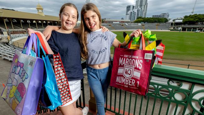 11-year-olds Annabelle Cotter and Eve Roberts at RNA Showgrounds with EKKA showbags. Picture: Richard Walker