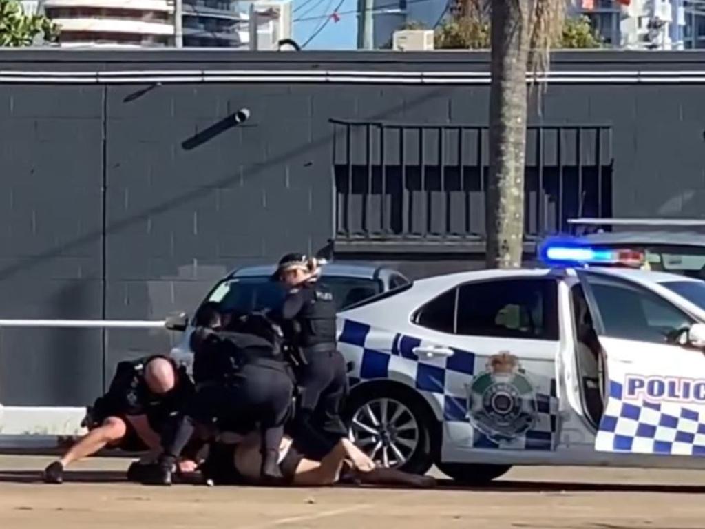 Police take a man into custody after a tense standoff on the Gold Coast on Tuesday morning. Picture: Facebook