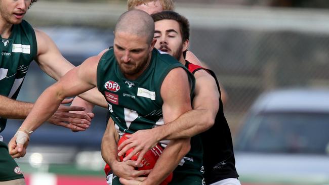 Airport West’s David Saliba is wrapped by Pascoe Vale’s Sam Caruso on Saturday. Photo: Mark Wilson