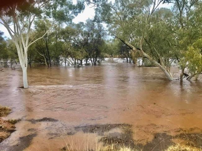 Katrina Dare from May Downs Station reported their normally bone-dry creek transformed into a flowing sea of brown. Photo Supplied Facebook Katrina Dare