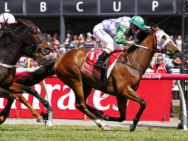 Michelle Payne wins the Melbourne Cup on Prince Of Penzance in front of Frankie Dettori onboard Max Dynamite. Picture: Colleen Petch