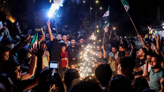 Syrians gather in the rebel-held northwestern city of Idlib following an Israeli air strike on a Beirut Hezbollah bunker. Picture: AFP