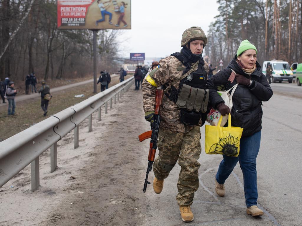 Ukrainian servicemen co-ordinate the evacuation of civilians near Irpin, Ukraine. Picture: Getty Images