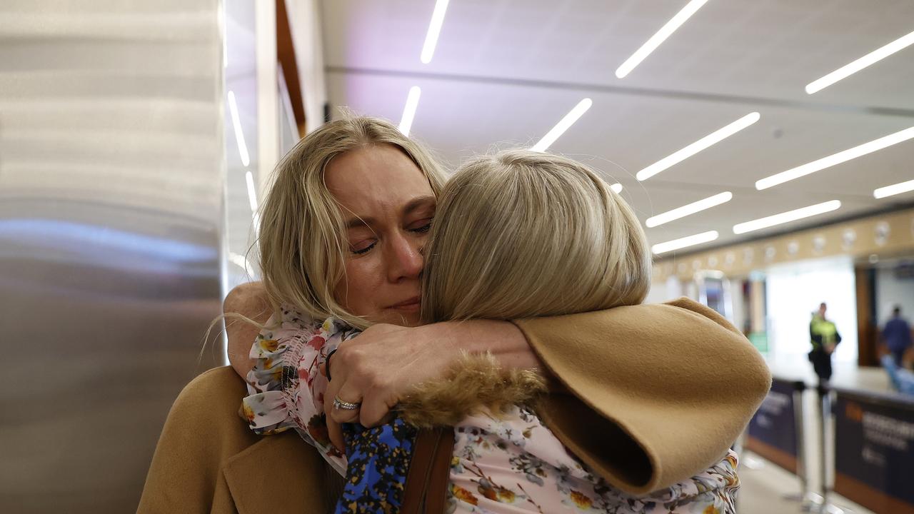 Amanda Osuchowski is reunited with her mum Kerry Stallard after arriving on the first flight from Melbourne at Hobart airport after the borders reopened to Victoria today. Picture: Zak Simmonds