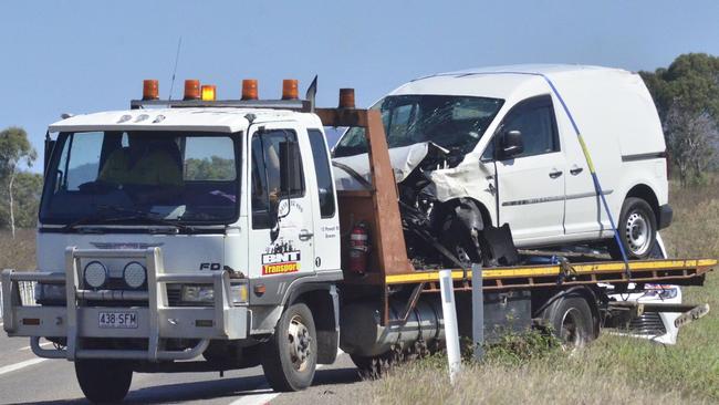 A tow truck moves a van from the scene of a fatal crash on the Bruce Highway near Bowen where a woman died.