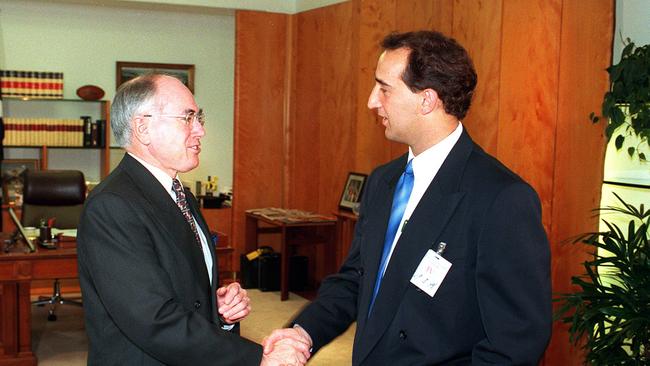 Aust politician Prime Minister John Howard (l) shaking hands with Walter Mikac (r) husband and father of Port Arthur shooting massacre victims discussing gun laws.