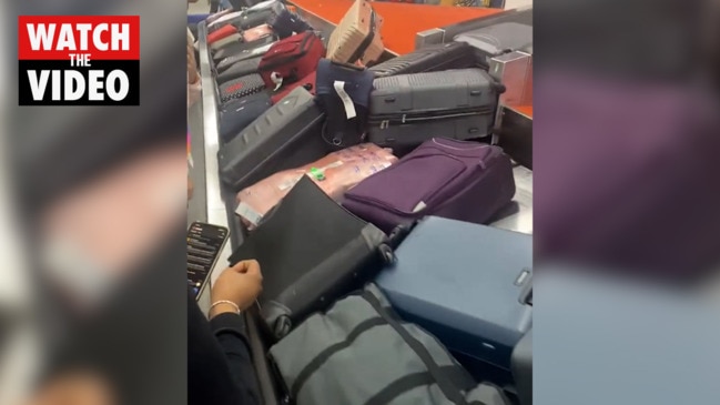 Insane luggage pile up at JFK airport as thousands of flights delayed or cancelled