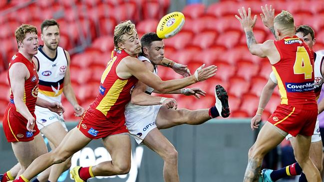 Hugh Greenwood of the Suns tackles Rory Laird of the Crows. The Crows’ pressure has been way off in the pressure stakes (AAP Image/Dave Hunt)