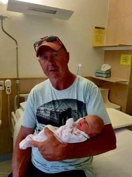 John Durie holding his granddaughter, Grace.