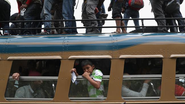 Members of a migrant caravan on a bus to show their IDs at a Guatemalan police checkpoint while en route to the border with Mexico. Picture: Getty Images