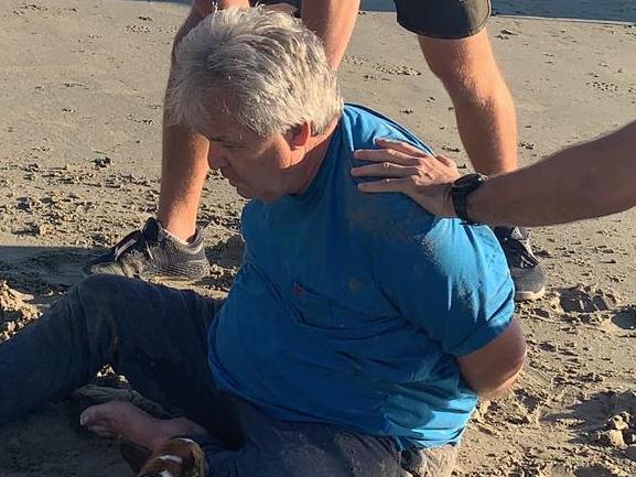 EXCLUSIVE .  DAILY TELEGRAPH SPECIAL. Disgraced businessman and conman Peter Foster is arrested by detectives on a Port Douglas beach this morning.