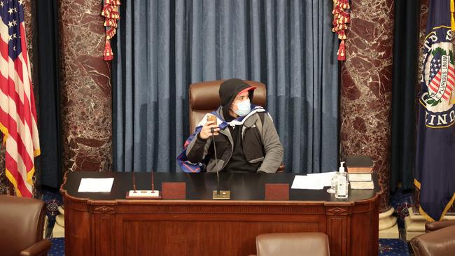 A protester sits in the Senate chamber on Thursday. Picture: AFP