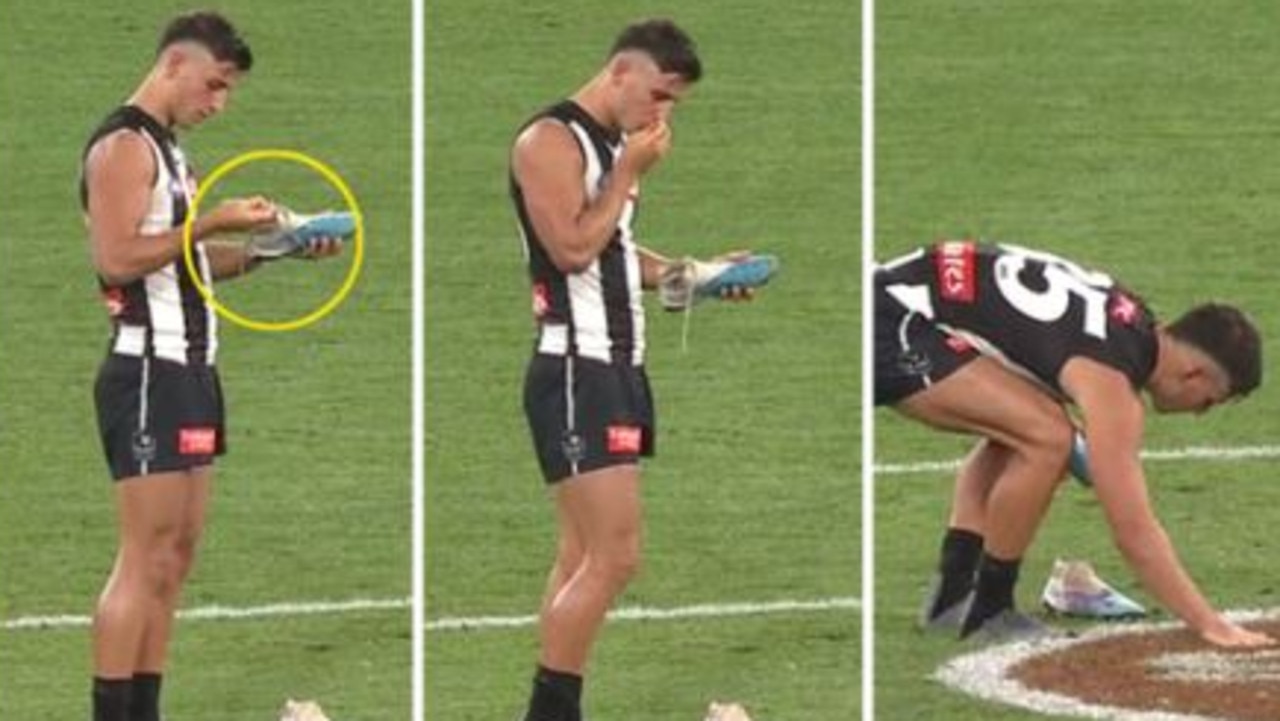 Nick Daicos places a rose petal on the MCG turf in honour of his late grandfather. Photo: Ch 7