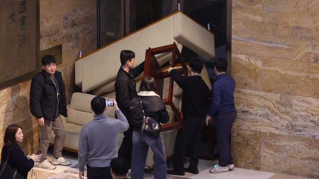 Members of South Korea's main opposition Democratic Party set up barricades at an entrance of the National Assembly building. Picture: Yonhap/AFP