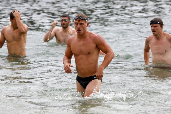 Gold Coast Suns players Darcy Macpherson (middle/front) and Nick Holman (right) training at Palm Beach. Picture: Tertius Pickard